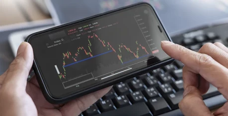 Smart phone screen showcasing financial line charts and asset performance