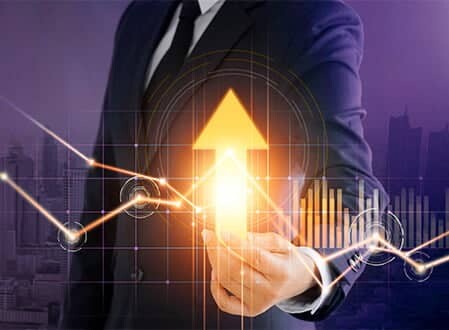 Businessman pointing to a glowing golden arrow showing financial upward trends